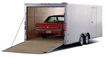 Vehicle inside an enclosed auto transport trailer for premium car shipping protection