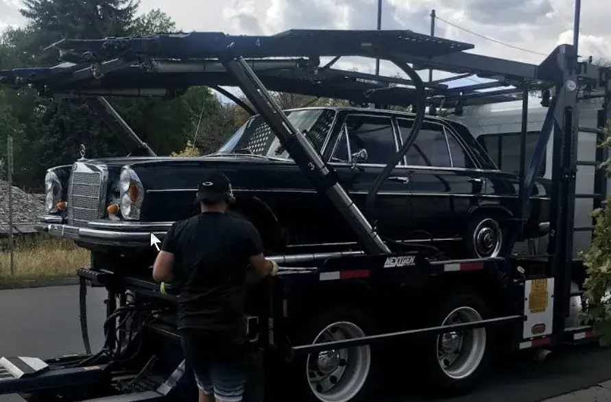 A car transport carrier loading a vehicle onto the truck