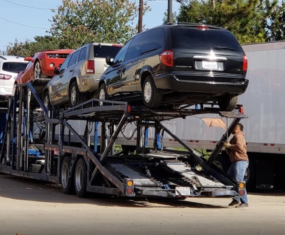 A car transport carrier delivering a vehicle to a customer by American Auto Shipping