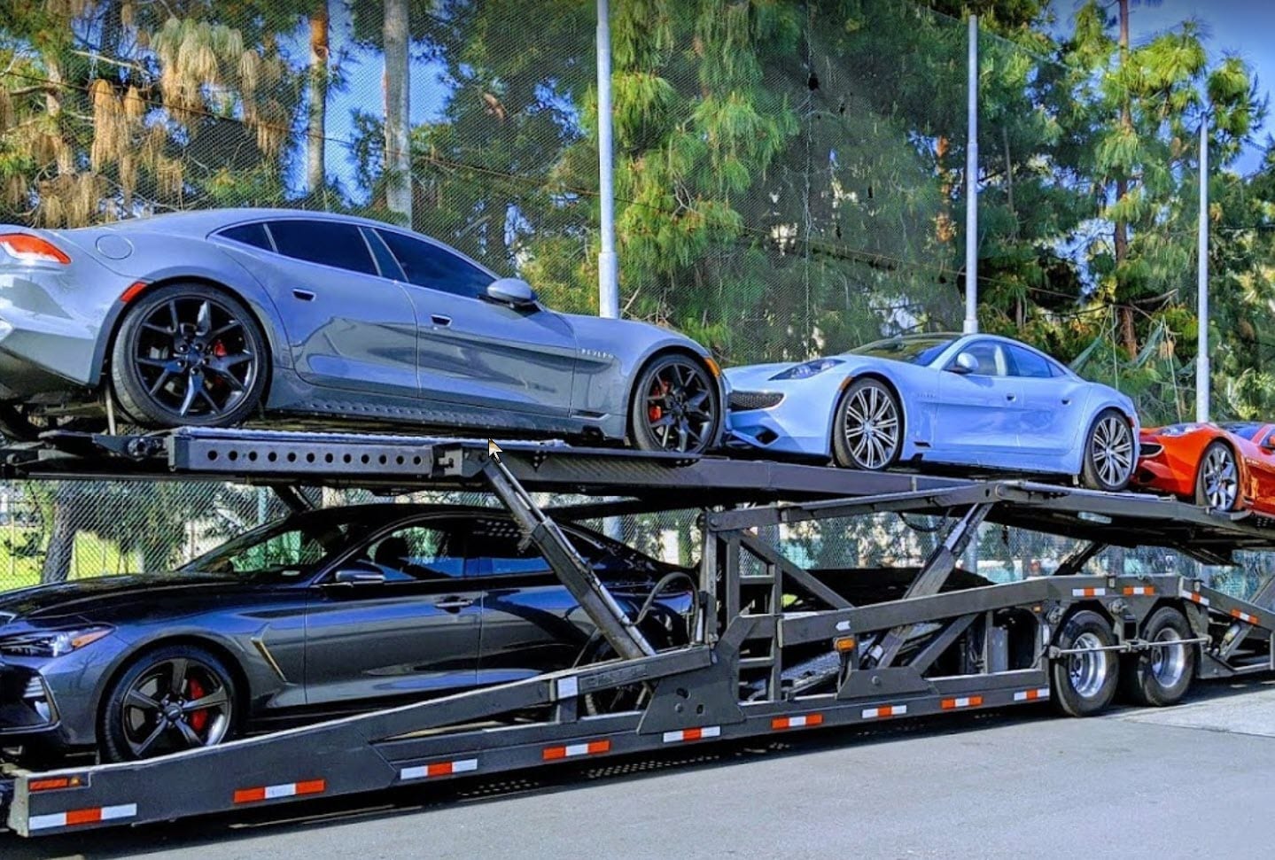 Vehicles on a car transport truck en route to their destination by American Auto Shipping